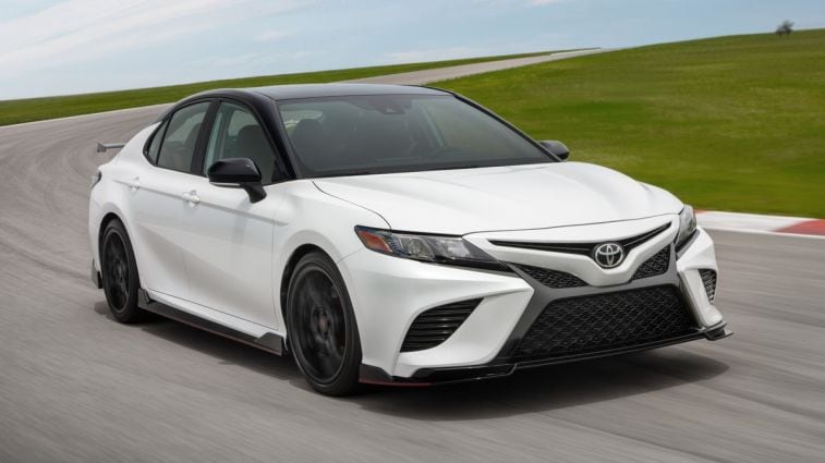 2024 Toyota Camry TRD in white driving on a track.
