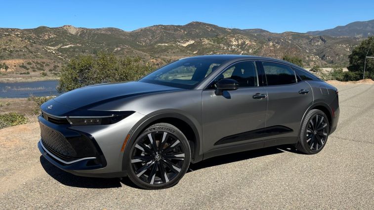 2024 Toyota Crown in grey with hills in the background.
