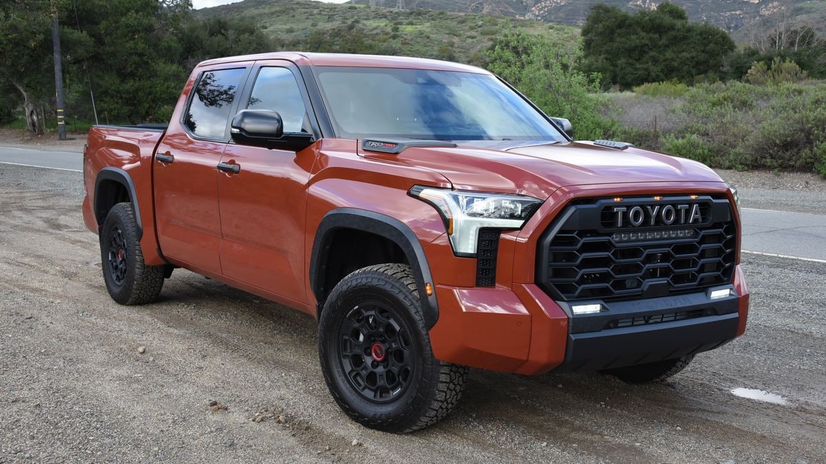 2024 Toyota Tundra TRD Pro parked on dirt with trees in the background.