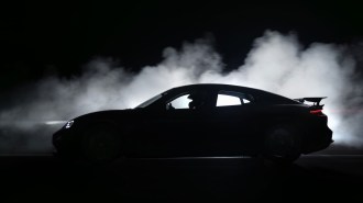 A teaser image showing a high-performance variant of the 2025 Porsche Taycan