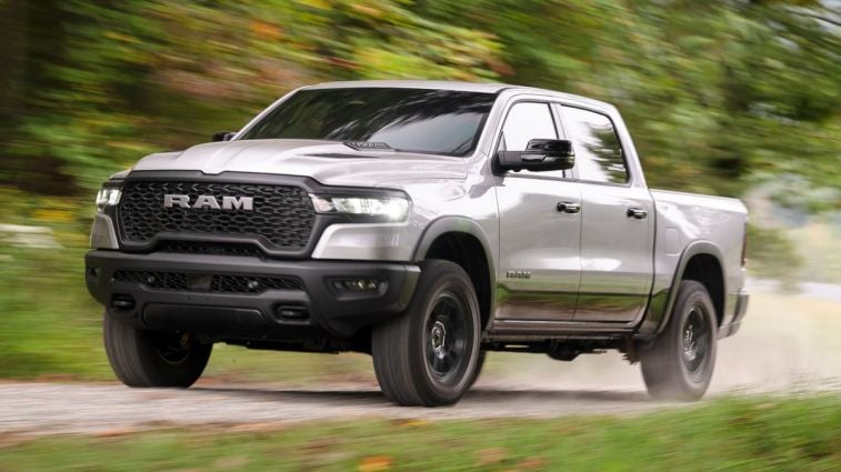 2025 Ram 1500 Rebel driving down a dirt road.