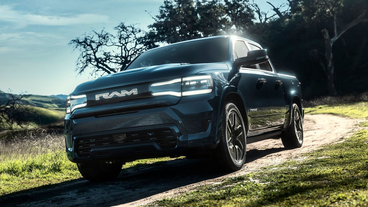 2025 Ram 1500 REV in blue parked a dirt road.