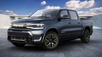 2025 Ram 1500 REV in blue with the sky in background.