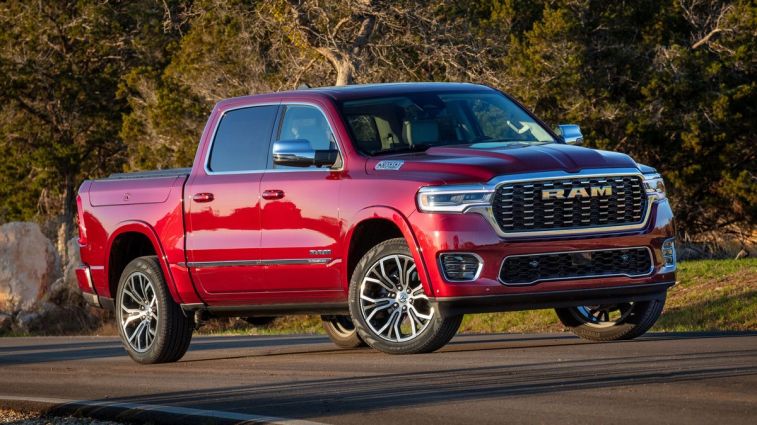 2025 Ram 1500 Tungsten in red with trees in the background.