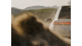 A teaser photo showing the rear of the 2025 Rivian R2 SUV