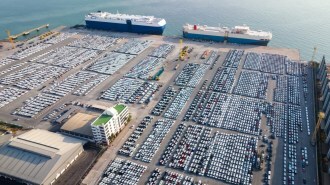 Cars lined up in port, awaiting transport onto car carrier ships