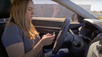 An IIHS researcher tests a driver attention monitor.