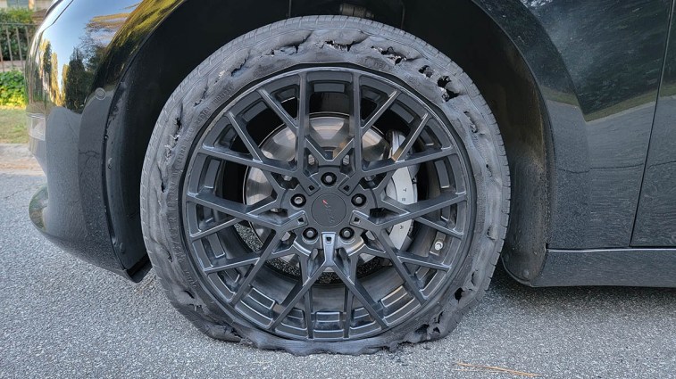 A Tesla's front tire with damaged sidewall.