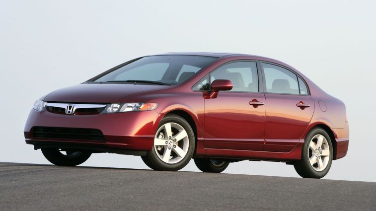 2007 Honda Civic Sedan in red at sunset.