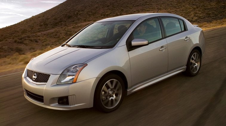 2009 Nissan Sentra driving down a desert road.