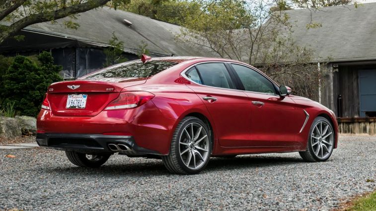 2021 Genesis G70 in red parked in front of a home.