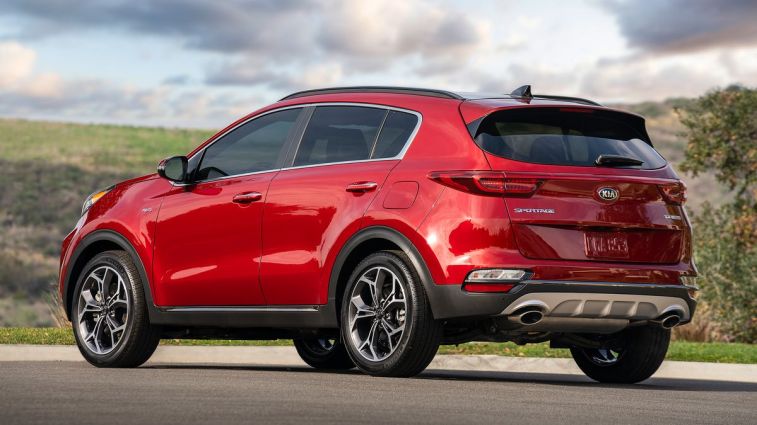 2021 Kia Sportage with clouds and hills in the background.