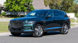2024 Genesis GV80 parked on a residential street.