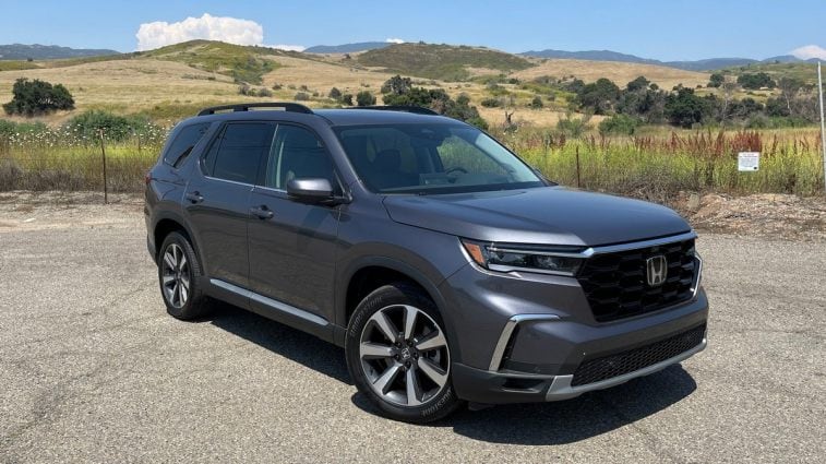 2024 Honda Pilot Elite in gray with hills behind.