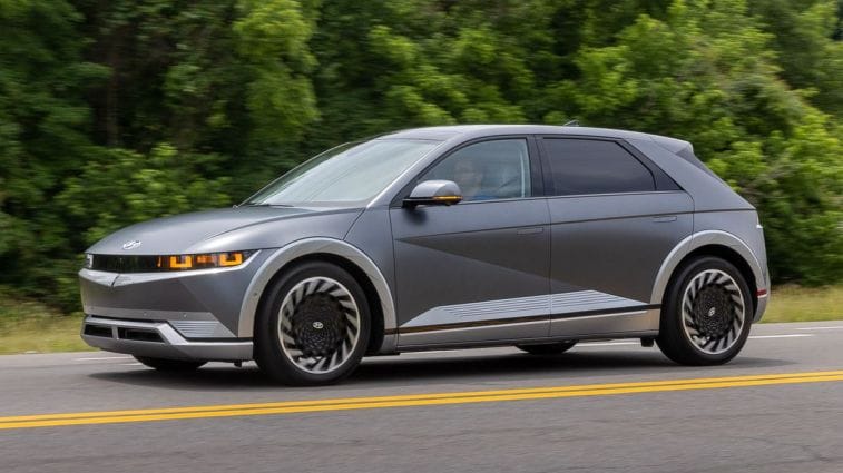 2024 Hyundai Ioniq 5 driving down a road.