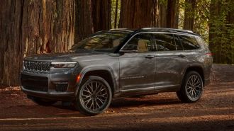 2024 Jeep Grand Cherokee L Summit Reserve parked near a grove of sequoias.