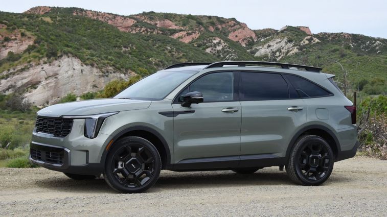 2024 Kia ​​Sorento X-Line in jungle green with hills in the background.