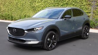 2024 Mazda CX-30 in grey with an ivy wall in the background.