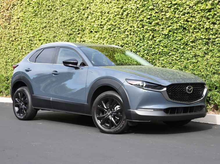 2024 Mazda CX-30 in grey with an ivy wall in the background.