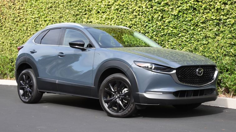 2024 Mazda CX-30 in grey with an ivy wall in the background.