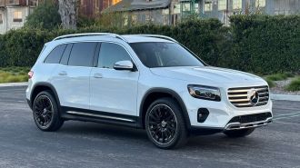2024 Mercedes-Benz GLB 250 in white with a metal barn in the background.