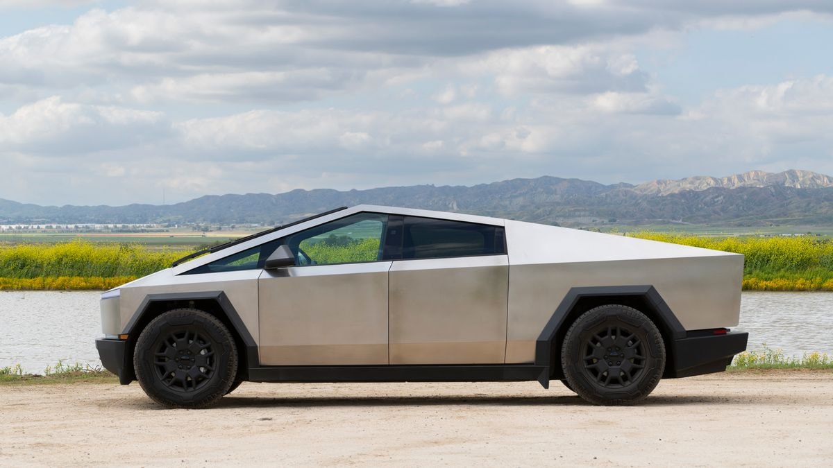 2024 Tesla Cybertruck with a lake and hills in the background.