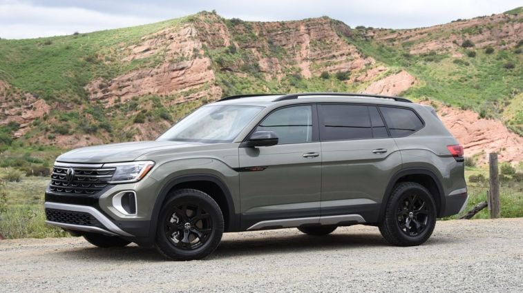 2024 Volkswagen Atlas Peak Edition in Avocado Green with red hills in the background.