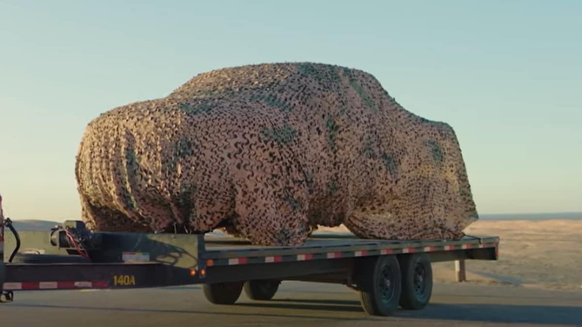 A teaser photo showing the 2025 Ram RHO under a camouflage cover
