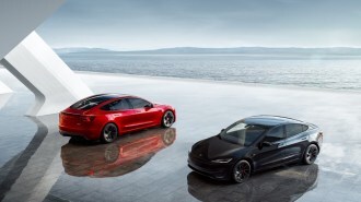 A pair of Tesla Model 3 Performance sedans sit side-by-side