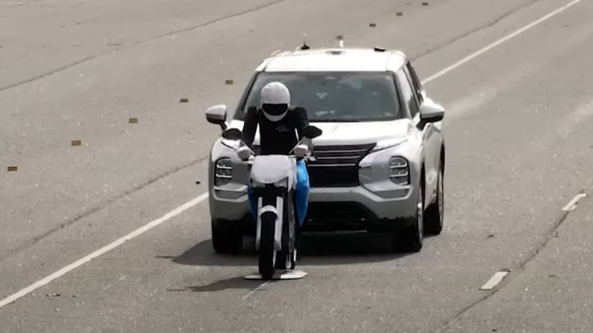 An SUV approaches a model of a motorcyclist in an Insurance Institute for Highway Safety automatic emergency braking test