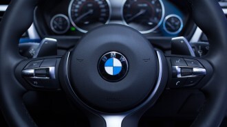 A BMW logo on a steering wheel