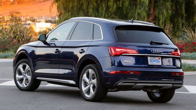 2021 Audi Q5 at sunset with trees in the background.