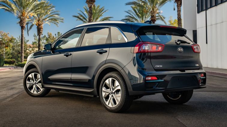 2021 Kia Niro EV in black with palm trees in the background.