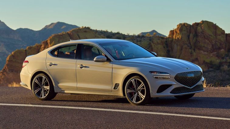 2024 Genesis G70 at sunset with rock formations in the background.