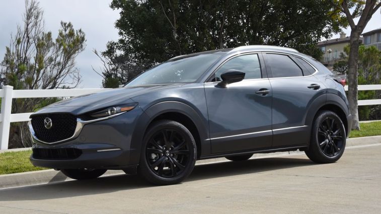 2024 Mazda CX-30 with a white fence in the background.
