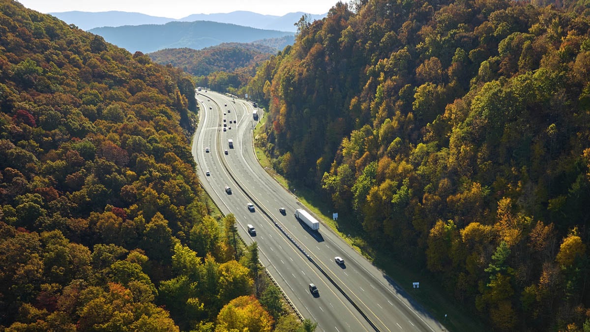 Cars driving on an interstate highway.