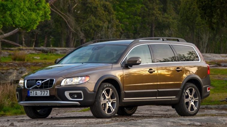 2013 Volvo XC70 with trees in the background.