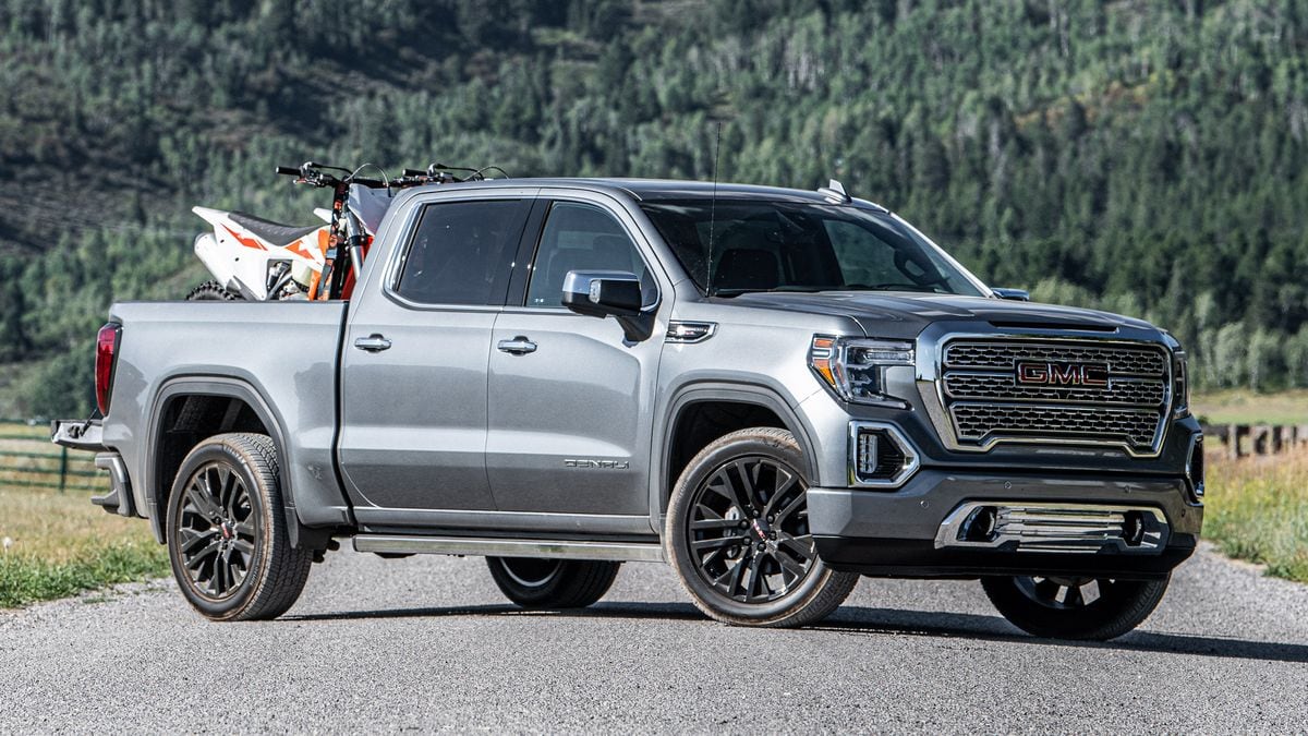 2021 GMC Sierra Denali with pine trees in the background.