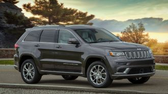 2021 Jeep Grand Cherokee Summit parked on a road.