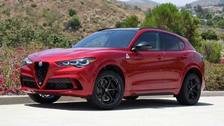 2024 Alfa Romeo Stelvio Quadrifoglio in Russo (Red) Etna with hills in the background.