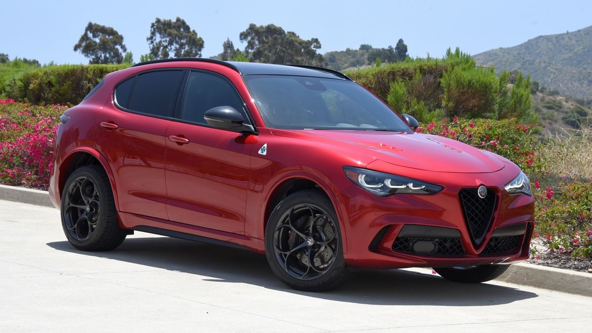2024 Alfa Romeo Stelvio Quadrifoglio in Russo (Red) Etna with hills in the background.