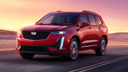 2024 Cadillac XT6 Sport driving in the desert at sunset.