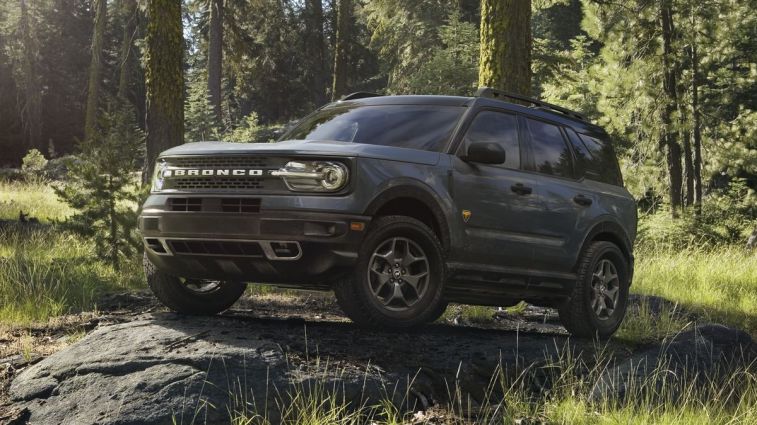2024 Ford Bronco Sport Badlands parked on a rock in the forest.