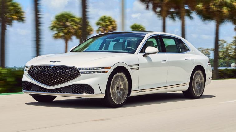 2024 Genesis G90 in white driving on a road.