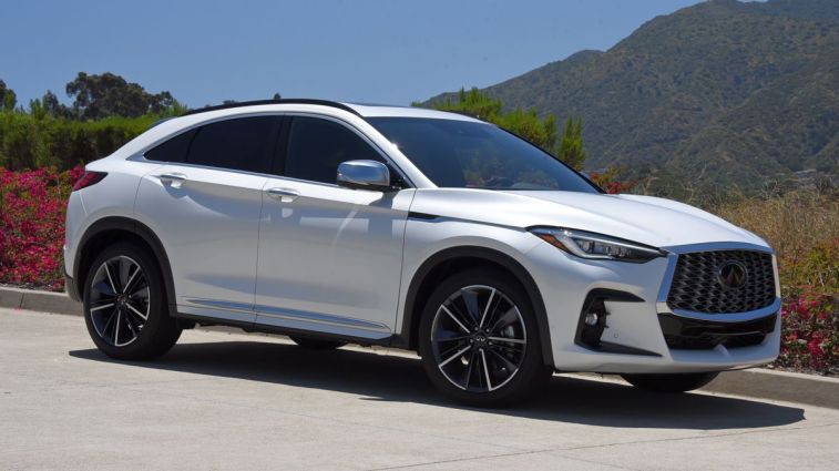 2024 Infiniti QX55 in Radiant White with hills in the background.