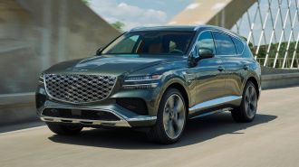 2025 Genesis GV80 driving over a bridge.