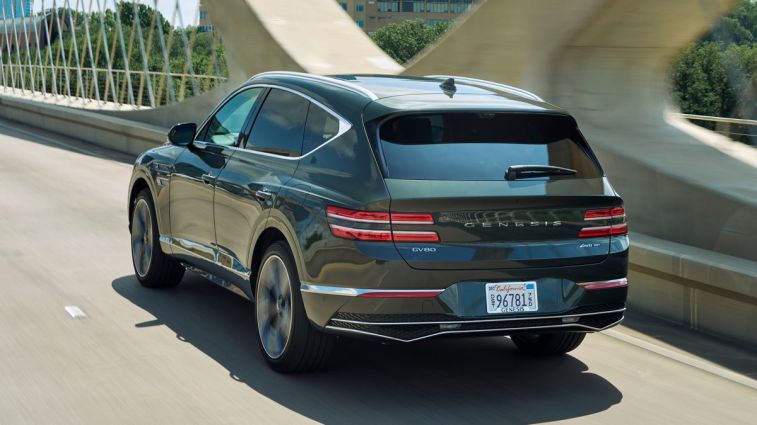2025 Genesis GV80 driving over a bridge.