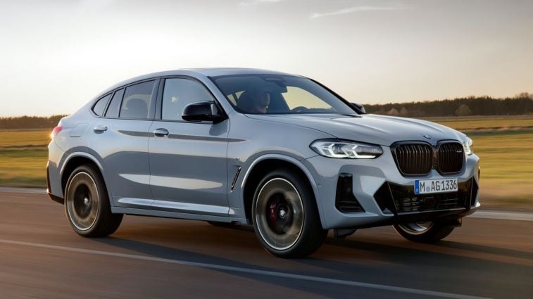 2024 BMW X4 in Brooklyn Grey driving on a road.