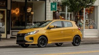 2024 Mitsubishi Mirage parked in front of boutique stores.