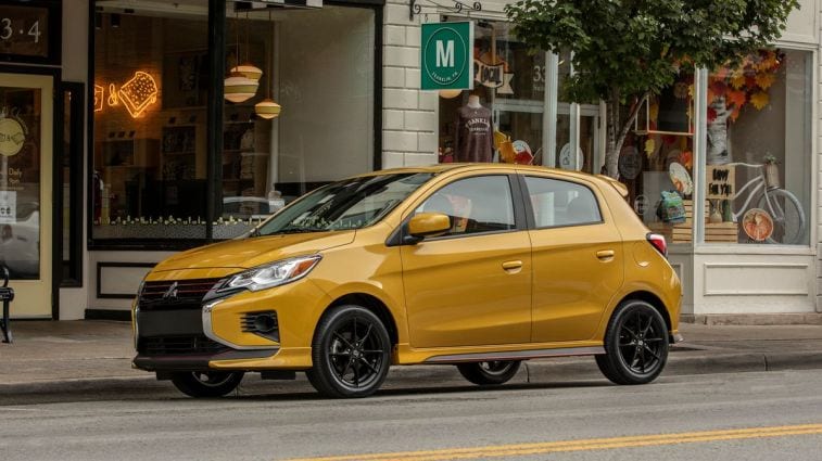 2024 Mitsubishi Mirage parked in front of boutique stores.